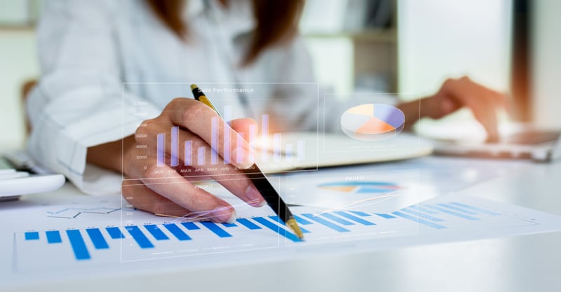 Woman Analyzing Charts pointing with pen