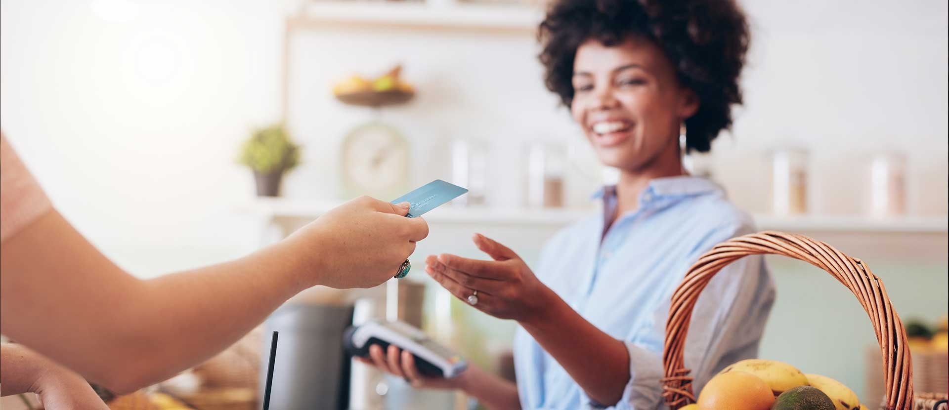 Woman using Debit Card at store